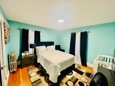 a bedroom with a bed with blue walls and curtains at Fearlessrose vacation Rental 89 in Springfield