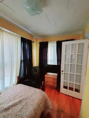 a bedroom with a bed and curtains and a window at Fearlessrose vacation Rental 89 in Springfield