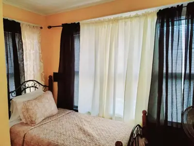 a bedroom with a bed and a window with curtains at Fearlessrose vacation Rental 89 in Springfield