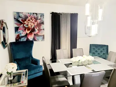 a dining room with a glass table and blue chairs at Fearlessrose vacation Rental 89 in Springfield