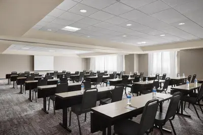 a conference room with tables and chairs in it at Courtyard by Marriott Newark Downtown in Newark