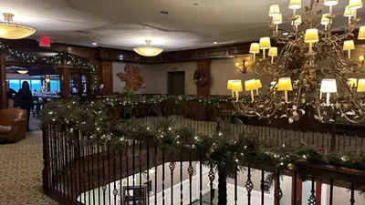 a hotel lobby with a chandelier and christmas decorations at Ski on Ski off Mtn Chalet in Vernon