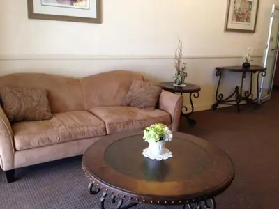 a living room with a couch and a coffee table at Inn at Arbor Ridge Hotel and Conference Center in Hopewell Junction
