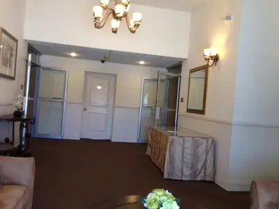 a living room with a table in a room at Inn at Arbor Ridge Hotel and Conference Center in Hopewell Junction