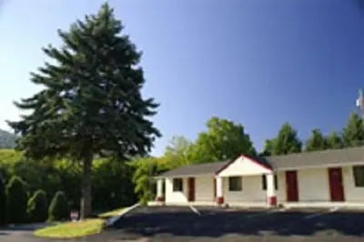 a house with a tree in front of it at Appalachian Motel in Vernon