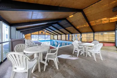 a room with tables and chairs and a pool at Red Roof Inn & Suites Newburgh - Stewart Airport West Point in New Windsor
