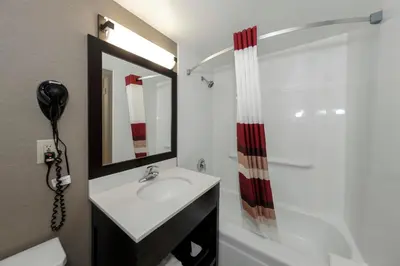 a bathroom with a sink and a shower at Red Roof Inn & Suites Newburgh - Stewart Airport West Point in New Windsor