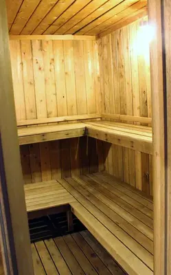 an empty sauna with wooden walls and wooden floors at Austrian Haus Lodge in West Dover