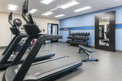 a gym with treadmills and exercise bikes in it at Hampton Inn & Suites Hartford-Manchester in Manchester