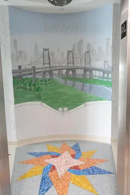 a mural of a bridge with stars on a wall at Nesva Hotel - New York City Vista in Queens