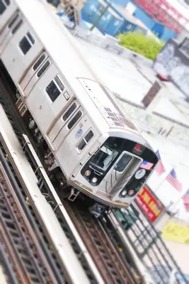a silver train is traveling down the tracks at Nesva Hotel - New York City Vista in Queens