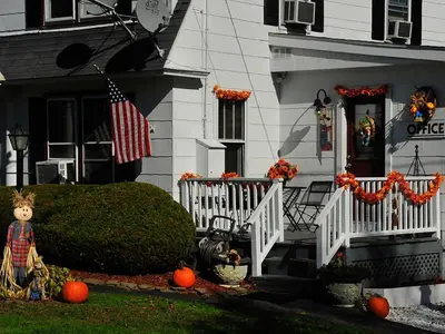 a house with an american flag and pumpkins on the front porch at Willows Motel in Williamstown