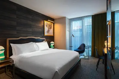 a bedroom with a bed and a desk and a chair at Renaissance New York Chelsea Hotel in New York