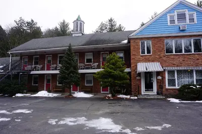 a brick house with a parking lot in front of it at Stay Berkshires in Williamstown