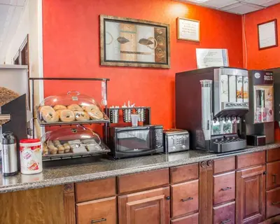 a kitchen with a counter with a bunch of donuts at Rodeway Inn Huntington Station - Melville in Huntington