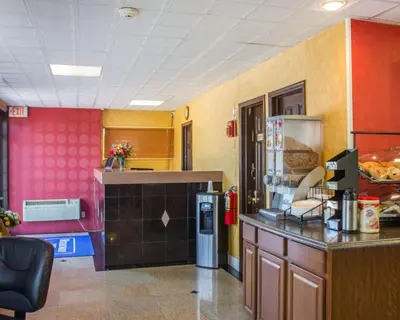 a kitchen with a counter and a refrigerator at Rodeway Inn Huntington Station - Melville in Huntington