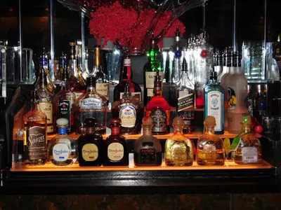 a bar with a bunch of bottles of alcohol at West Gate Inn Nyack in Nyack
