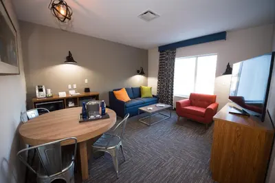 a living room with a table and a couch at The Kartrite Resort and Indoor Waterpark in Monticello