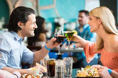 a man and woman sitting at a table with glasses of wine at The Kartrite Resort and Indoor Waterpark in Monticello