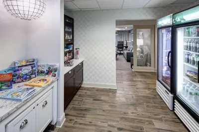a pharmacy aisle with a refrigerator and a hallway at Homewood Suites by Hilton Mahwah in Mahwah