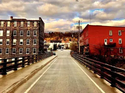 an empty street in a city with a red building at The Inn At Stone Mill in Little Falls