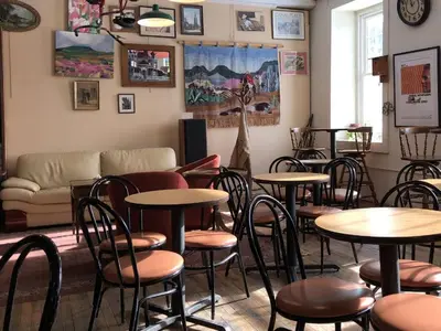 a restaurant with tables and chairs and a couch at The Inn At Stone Mill in Little Falls