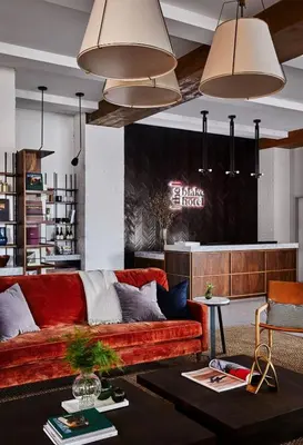 a living room with a red couch and a table at The Blake Hotel in New Haven