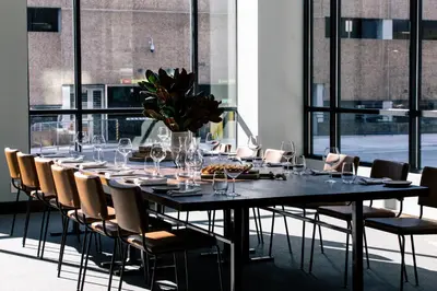 a long table with chairs and wine glasses on it at The Blake Hotel in New Haven