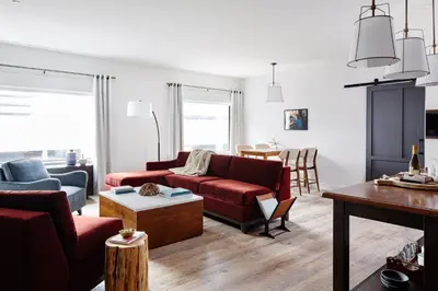 a living room with a red couch and a table at The Blake Hotel in New Haven