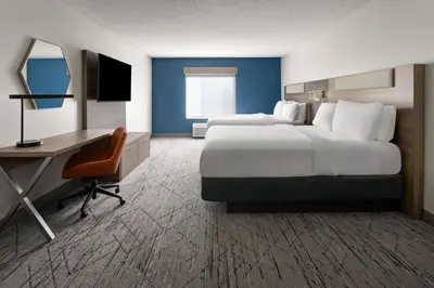 a large hotel room with a bed and a desk at Holiday Inn Express and Suites Meriden by IHG in Meriden