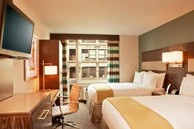 a hotel room with two beds and a flat screen tv at Holiday Inn Express - Times Square South by IHG in New York