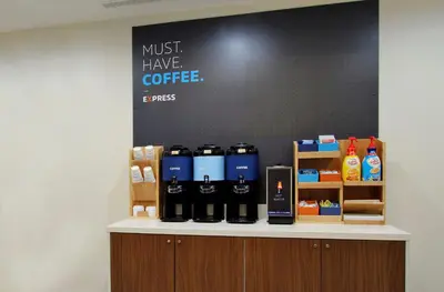 a counter with bottles of coffee on it at Holiday Inn Express - Times Square South by IHG in New York