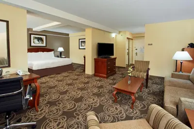 a hotel room with a bed and a couch at DoubleTree by Hilton Mahwah in Mahwah