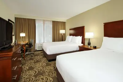 a hotel room with two beds and a flat screen tv at DoubleTree by Hilton Mahwah in Mahwah