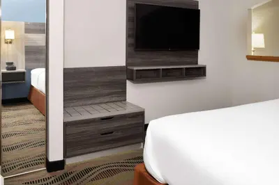 a hotel room with a bed and a flat screen tv at Baymont by Wyndham Budd Lake in Budd Lake