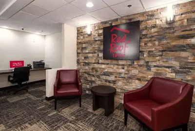 a waiting room with two chairs and a red rock wine sign at Red Roof Inn Hartford- New Britain in New Britain