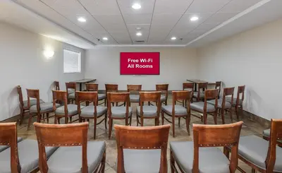 a room with a group of chairs and a sign at Red Roof Inn Hartford- New Britain in New Britain