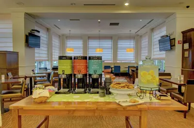 a table with a bunch of bottles of wine on it at Hilton Garden Inn Norwalk in Norwalk
