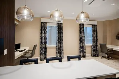 a conference room with a white table and chairs at Crowne Plaza Albany - The Desmond Hotel in Albany