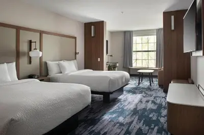a hotel room with two beds and a window at Fairfield Inn & Suites by Marriott Williamstown in Williamstown