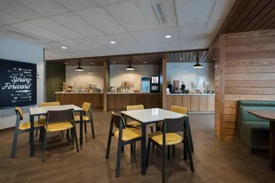 a restaurant with two tables and chairs and a counter at Fairfield Inn & Suites by Marriott Williamstown in Williamstown