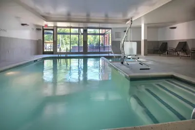 a swimming pool with blue water in a building at Fairfield Inn & Suites by Marriott Williamstown in Williamstown