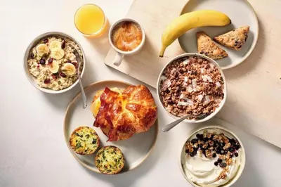 a table with plates of breakfast foods and drinks at Fairfield Inn & Suites by Marriott Williamstown in Williamstown