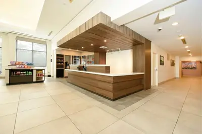 a large kitchen with a counter in a house at Hilton Garden Inn Saratoga Springs in Saratoga Springs