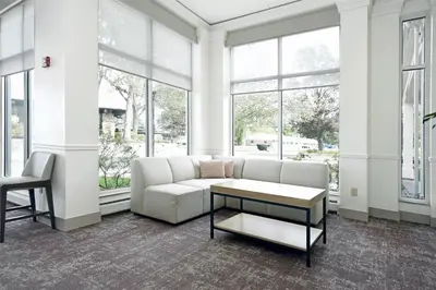 a living room with a couch and a table at Hilton Garden Inn Saratoga Springs in Saratoga Springs
