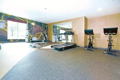 a gym with several exercise bikes and a treadmill at Hilton Garden Inn Saratoga Springs in Saratoga Springs