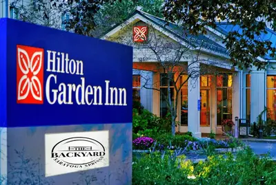 a sign in front of a garden inn at Hilton Garden Inn Saratoga Springs in Saratoga Springs