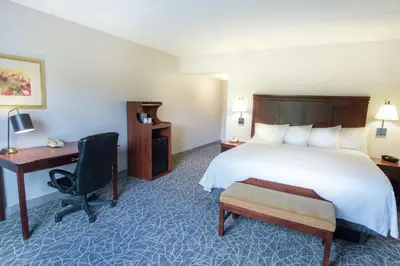 a hotel room with a bed and a desk at Hampton Inn & Suites Berkshires-Lenox in Lenox
