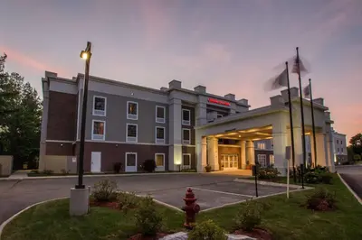 a building with a fire hydrant in front of it at Hampton Inn & Suites Berkshires-Lenox in Lenox