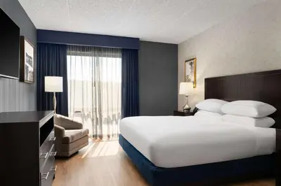 a hotel room with a large white bed and a window at DoubleTree by Hilton Bradley International Airport in Windsor Locks